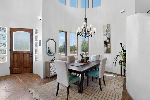 10 Francisco Rd, Cedar Crest, NM 87008 - dining room featuring a chandelier, healthy amount of natural light, and a towering ceiling