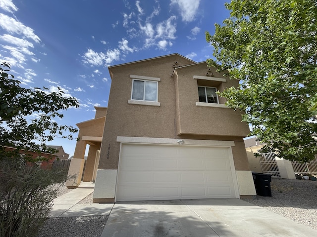 10608 Buck Island Rd SW, Albuquerque, NM 87121 - view of front facade with stucco siding, an attached garage, and driveway