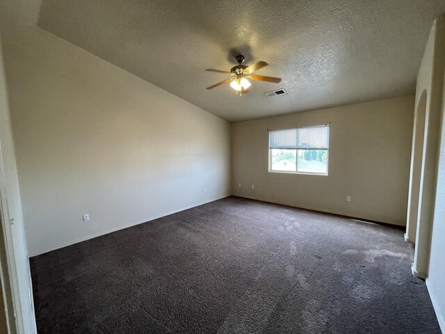 10608 Buck Island Rd SW, Albuquerque, NM 87121 - empty room featuring a ceiling fan, dark carpet, and a textured ceiling