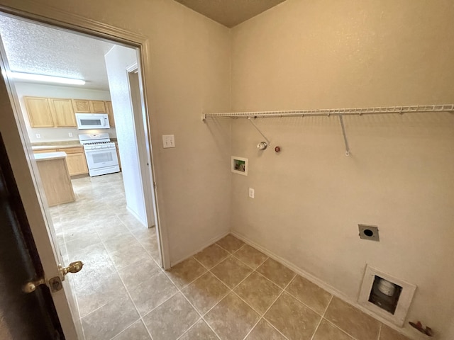 10608 Buck Island Rd SW, Albuquerque, NM 87121 - laundry room with hookup for an electric dryer, hookup for a washing machine, gas dryer hookup, and light tile patterned flooring