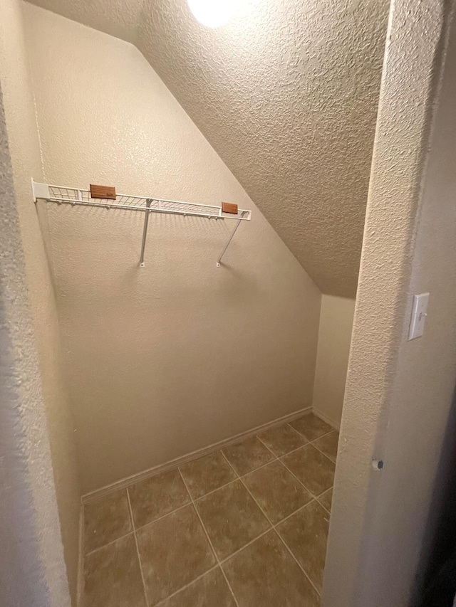 10608 Buck Island Rd SW, Albuquerque, NM 87121 - walk in closet with lofted ceiling and dark tile patterned flooring