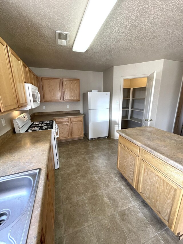 10608 Buck Island Rd SW, Albuquerque, NM 87121 - kitchen featuring white appliances and a textured ceiling