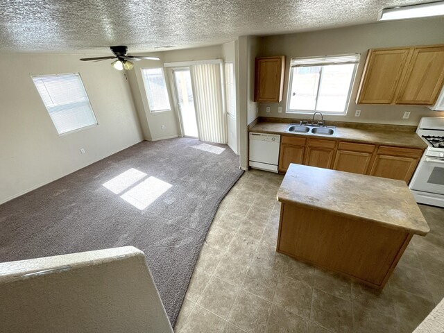 10608 Buck Island Rd SW, Albuquerque, NM 87121 - kitchen featuring white appliances, a textured ceiling, plenty of natural light, ceiling fan, and light countertops