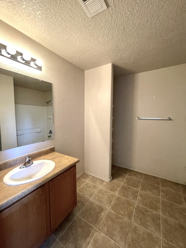 10608 Buck Island Rd SW, Albuquerque, NM 87121 - bathroom with vanity, a textured ceiling, and tile patterned floors