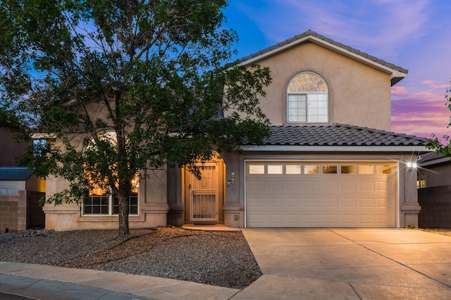 4840 Mcnary Ct NW, Albuquerque, NM 87120 - mediterranean / spanish-style home featuring driveway, stucco siding, an attached garage, and a tiled roof