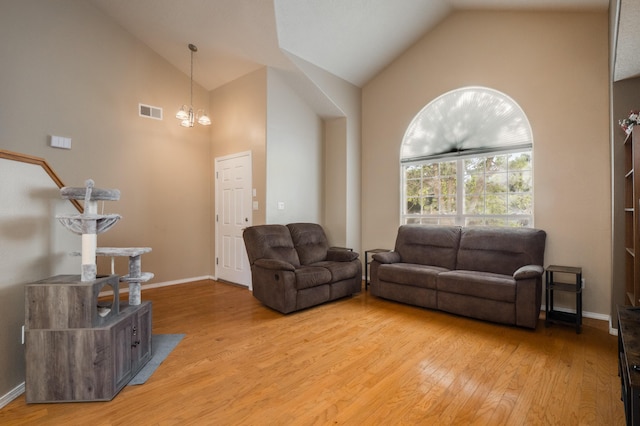 4840 Mcnary Ct NW, Albuquerque, NM 87120 - living room featuring light wood-style floors, a chandelier, and high vaulted ceiling