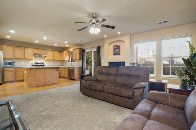 4840 Mcnary Ct NW, Albuquerque, NM 87120 - living room with recessed lighting, ceiling fan, light wood-style flooring, and a fireplace