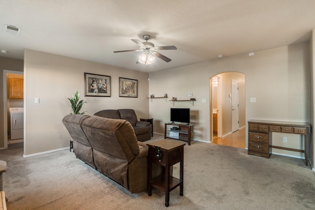 4840 Mcnary Ct NW, Albuquerque, NM 87120 - living room featuring arched walkways, carpet floors, washer / dryer, and ceiling fan