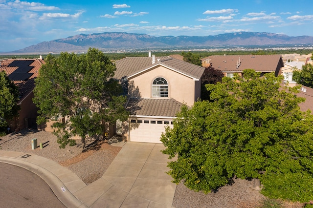 4840 Mcnary Ct NW, Albuquerque, NM 87120 - view of front facade featuring a tiled roof, driveway, a mountain view, and stucco siding