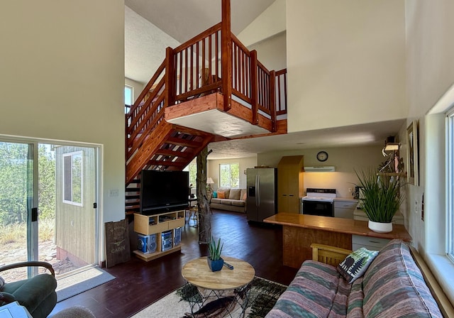 162 Black Bear Rd, Ramah, NM 87321 - living area featuring a towering ceiling, stairs, and wood finished floors