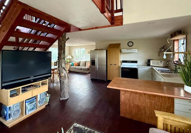 162 Black Bear Rd, Ramah, NM 87321 - kitchen featuring stainless steel fridge with ice dispenser, range with electric cooktop, under cabinet range hood, dark wood-type flooring, and white microwave
