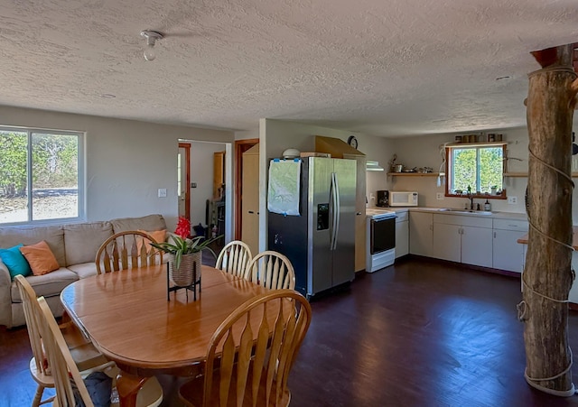 162 Black Bear Rd, Ramah, NM 87321 - dining area featuring a textured ceiling and dark wood-style flooring