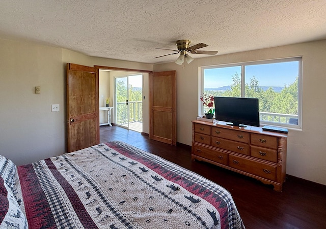 162 Black Bear Rd, Ramah, NM 87321 - bedroom with access to outside, dark wood-type flooring, a textured ceiling, and a ceiling fan