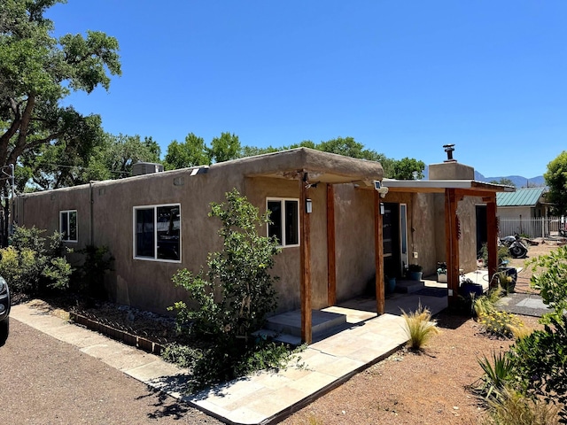 201 Marlowe Ln, Albuquerque, NM 87113 - view of property exterior featuring a chimney and stucco siding