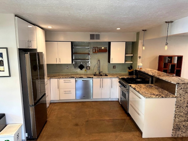 201 Marlowe Ln, Albuquerque, NM 87113 - kitchen with appliances with stainless steel finishes, finished concrete flooring, a peninsula, tasteful backsplash, and recessed lighting