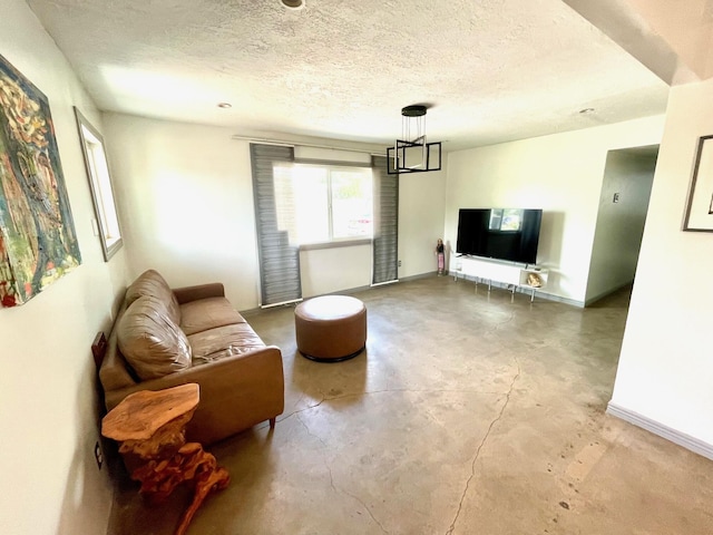 201 Marlowe Ln, Albuquerque, NM 87113 - living room featuring concrete floors, a textured ceiling, and a chandelier
