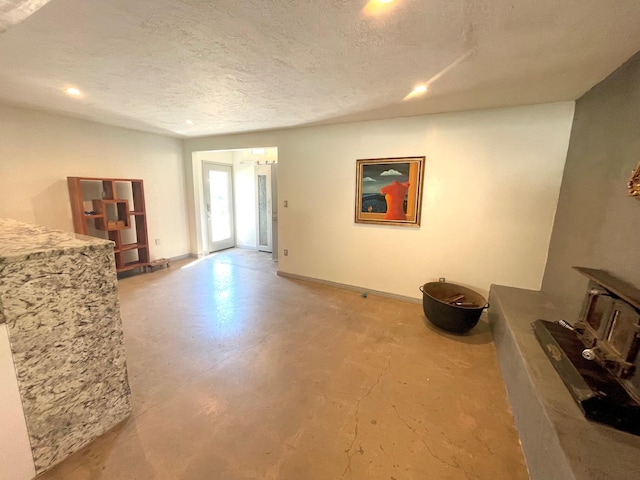 201 Marlowe Ln, Albuquerque, NM 87113 - living area featuring a wood stove, finished concrete floors, a textured ceiling, and recessed lighting