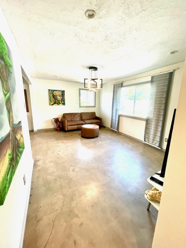201 Marlowe Ln, Albuquerque, NM 87113 - living area featuring concrete floors, a textured ceiling, and arched walkways