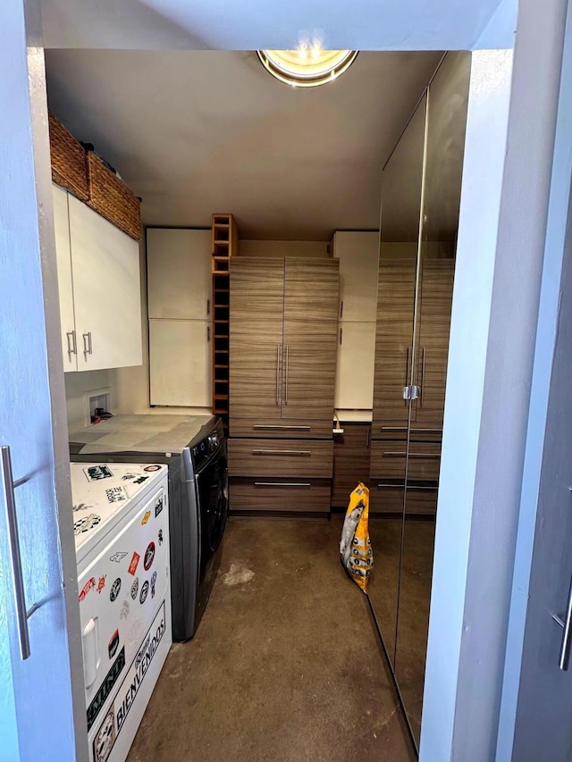 201 Marlowe Ln, Albuquerque, NM 87113 - kitchen featuring washing machine and clothes dryer, concrete flooring, and light countertops