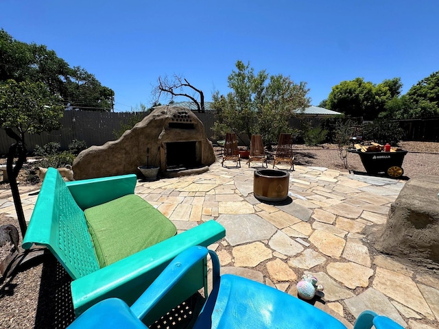 201 Marlowe Ln, Albuquerque, NM 87113 - fenced backyard featuring exterior fireplace and a patio
