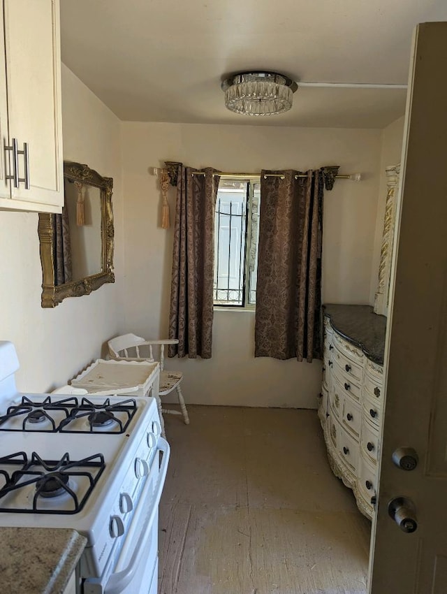 215 Tren Rd, Los Lunas, NM 87031 - kitchen featuring white range with gas cooktop and white cabinets