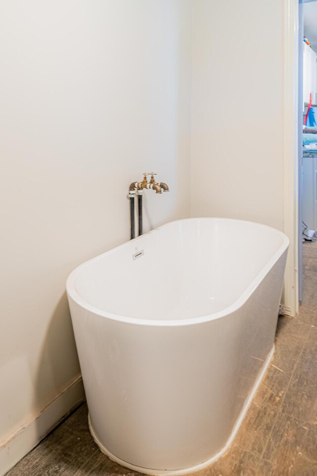 215 Tren Rd, Los Lunas, NM 87031 - full bathroom featuring a freestanding tub and wood finished floors