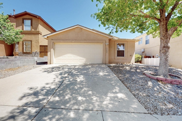 10409 Red Robin Rd SW, Albuquerque, NM 87121 - view of front of house featuring stucco siding, concrete driveway, and a garage