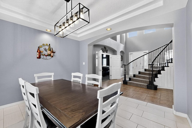 4420 Bentgrass Mdws NE, Rio Rancho, NM 87144 - dining space with arched walkways, stairs, light tile patterned floors, and recessed lighting