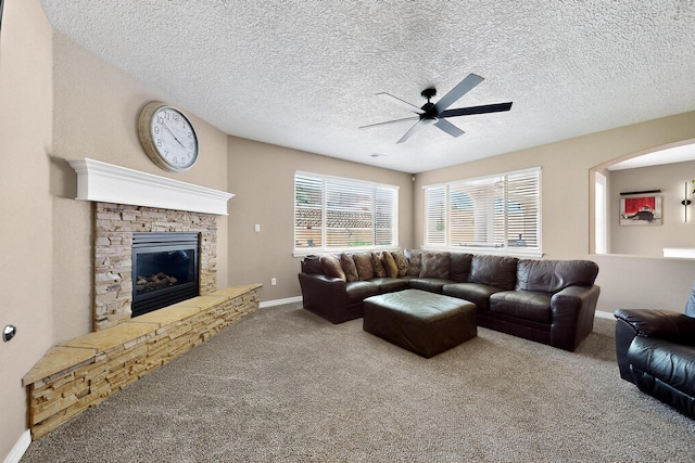 4420 Bentgrass Mdws NE, Rio Rancho, NM 87144 - living area featuring a ceiling fan, carpet floors, a fireplace, and a textured ceiling