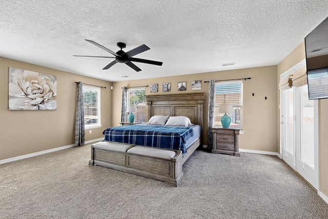 4420 Bentgrass Mdws NE, Rio Rancho, NM 87144 - bedroom with carpet floors, multiple windows, a ceiling fan, and a textured ceiling