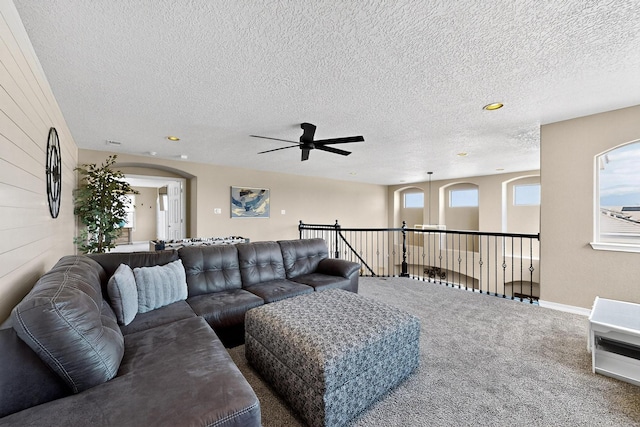 4420 Bentgrass Mdws NE, Rio Rancho, NM 87144 - living room with carpet floors, ceiling fan, a textured ceiling, arched walkways, and recessed lighting