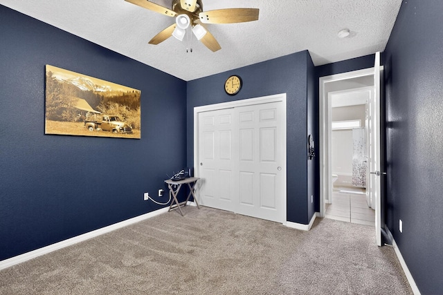 4420 Bentgrass Mdws NE, Rio Rancho, NM 87144 - bedroom with carpet, a textured ceiling, a closet, and ceiling fan