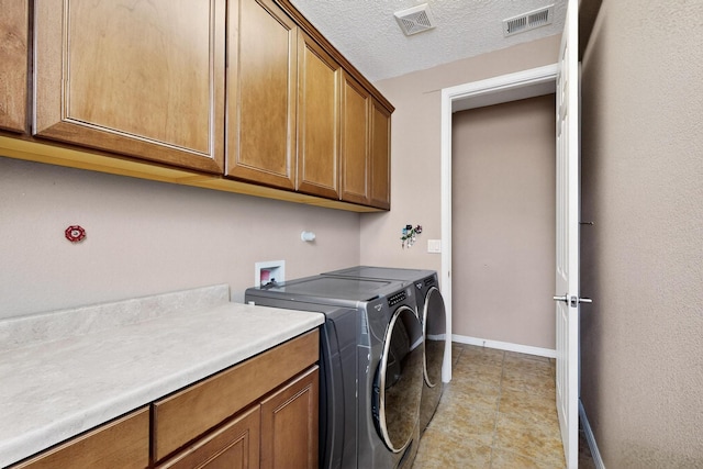 4420 Bentgrass Mdws NE, Rio Rancho, NM 87144 - laundry room featuring cabinet space, washing machine and clothes dryer, and a textured ceiling
