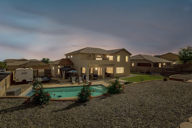4420 Bentgrass Mdws NE, Rio Rancho, NM 87144 - back of property featuring a patio area, a fenced backyard, stucco siding, and a putting green