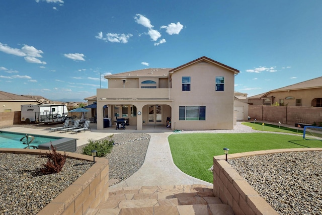 4420 Bentgrass Mdws NE, Rio Rancho, NM 87144 - back of house featuring stucco siding and a patio area