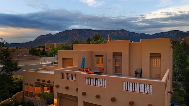 5808 Mariola Pl NE, Albuquerque, NM 87111 - back of property featuring a mountain view, stucco siding, a balcony, and an attached garage