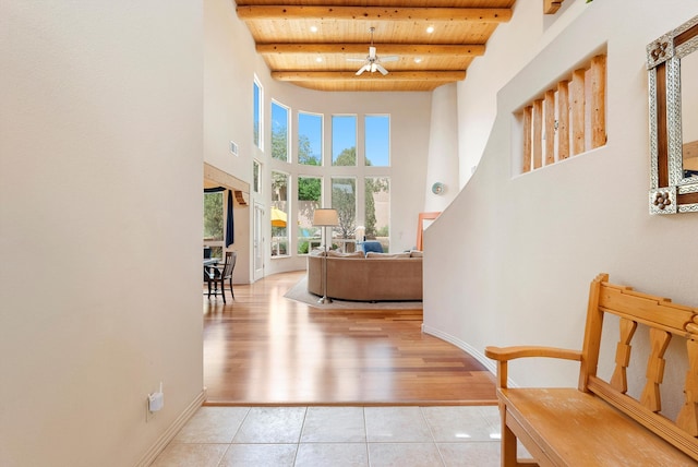 5808 Mariola Pl NE, Albuquerque, NM 87111 - foyer featuring a wood ceiling with exposed beams, a ceiling fan, a high ceiling, and light tile patterned flooring