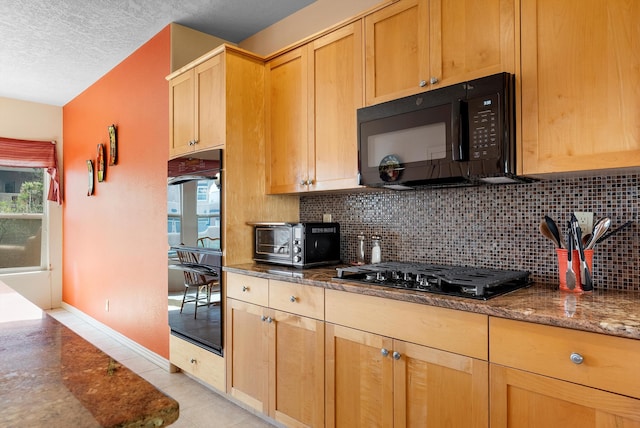 5808 Mariola Pl NE, Albuquerque, NM 87111 - kitchen with black appliances, backsplash, dark stone counters, a textured ceiling, and light tile patterned flooring