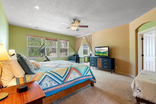 5808 Mariola Pl NE, Albuquerque, NM 87111 - bedroom with light carpet, a textured ceiling, ceiling fan, recessed lighting, and arched walkways