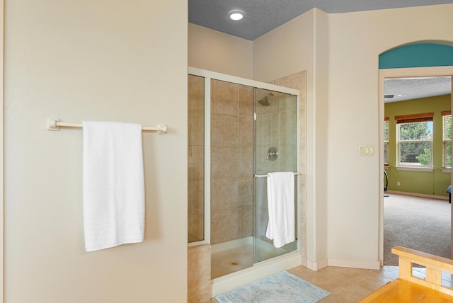 5808 Mariola Pl NE, Albuquerque, NM 87111 - full bathroom with a shower stall, tile patterned flooring, and a textured ceiling
