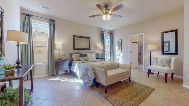 851 Vista Patron Dr, Bernalillo, NM 87004 - bedroom featuring light tile patterned floors, multiple windows, a textured ceiling, and ceiling fan