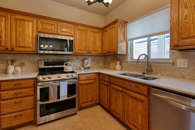 851 Vista Patron Dr, Bernalillo, NM 87004 - kitchen featuring stainless steel appliances, brown cabinets, and light countertops