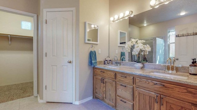 851 Vista Patron Dr, Bernalillo, NM 87004 - full bathroom with double vanity, a shower stall, tile patterned flooring, and a spacious closet