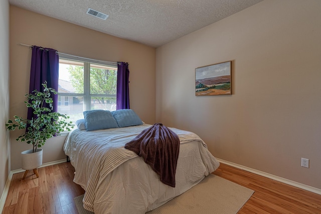 851 Vista Patron Dr, Bernalillo, NM 87004 - bedroom with wood finished floors and a textured ceiling