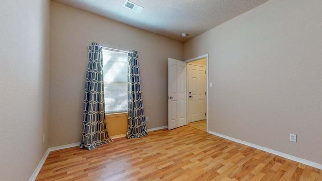851 Vista Patron Dr, Bernalillo, NM 87004 - unfurnished room with light wood-style floors and a textured ceiling