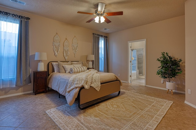 851 Vista Patron Dr, Bernalillo, NM 87004 - bedroom featuring a textured ceiling, a ceiling fan, and ensuite bath