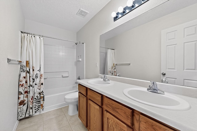 8905 Balsam Glade Rd NW, Albuquerque, NM 87114 - full bathroom featuring double vanity, shower / tub combo, tile patterned flooring, and a textured ceiling