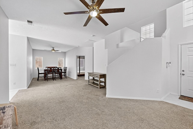 8905 Balsam Glade Rd NW, Albuquerque, NM 87114 - carpeted living area featuring a ceiling fan and a towering ceiling