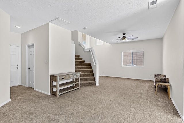 8905 Balsam Glade Rd NW, Albuquerque, NM 87114 - unfurnished living room featuring a ceiling fan, carpet, plenty of natural light, stairs, and a textured ceiling