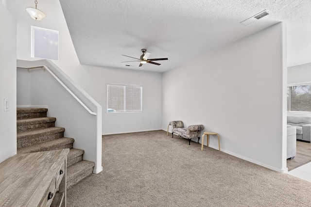 8905 Balsam Glade Rd NW, Albuquerque, NM 87114 - unfurnished room with a ceiling fan, carpet, stairs, and a textured ceiling